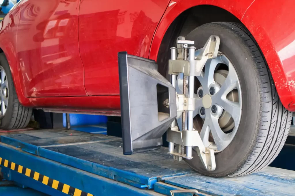 A red car wheel aligning, Auto repair services